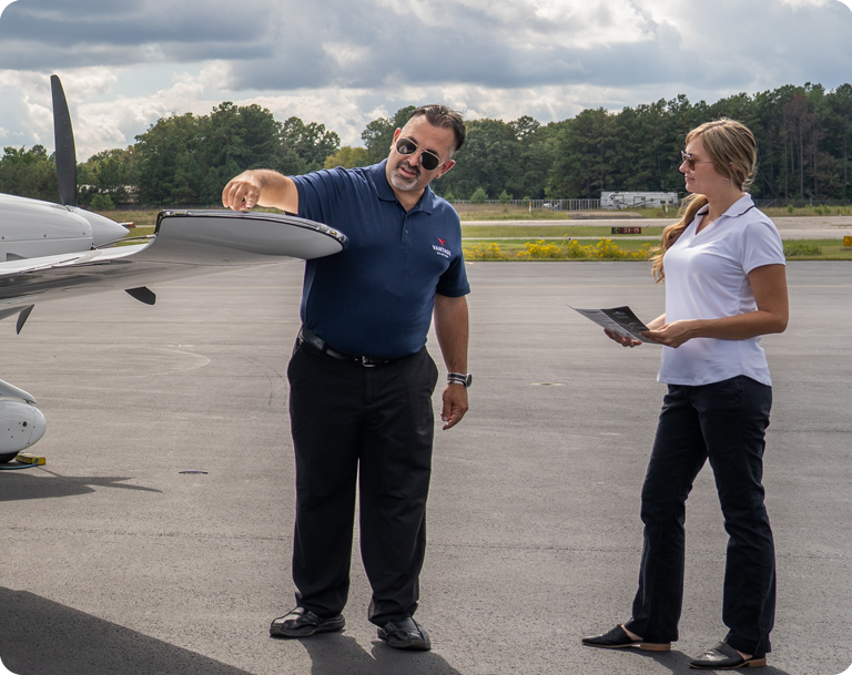 man and woman checking plane