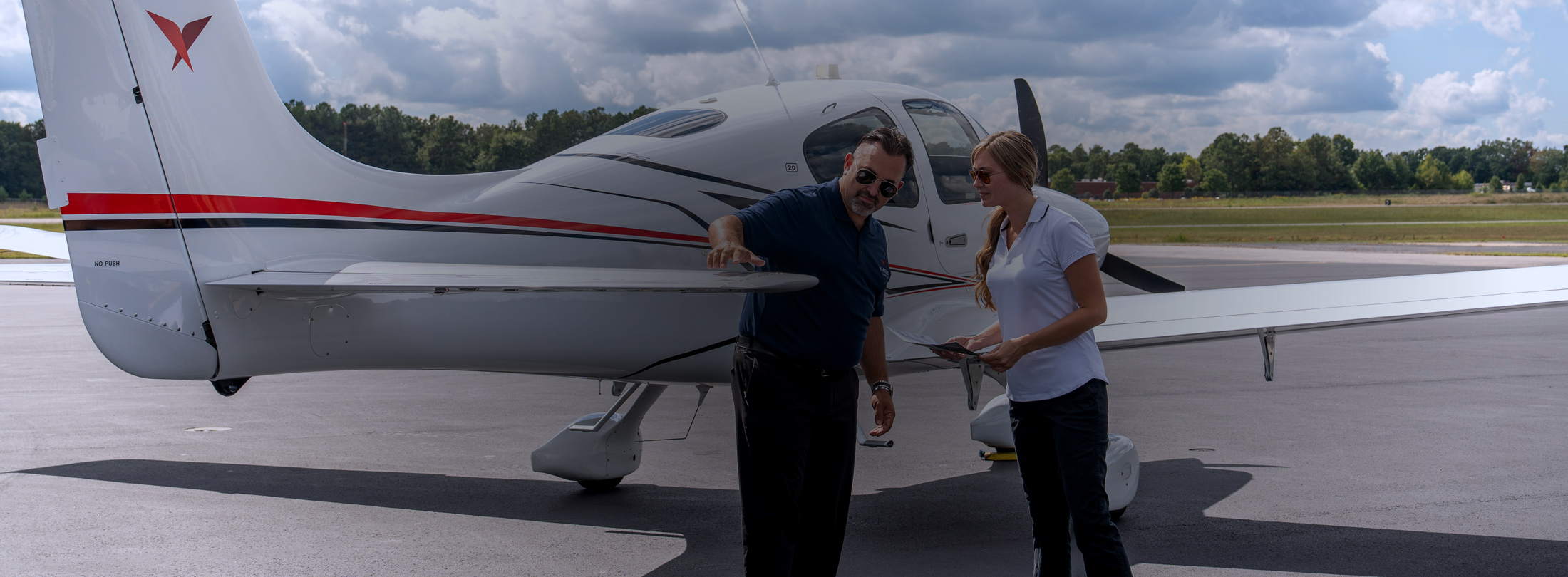 man and woman checking plane